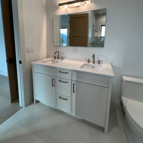 showroom bathroom, two sinks, mirror, white counters